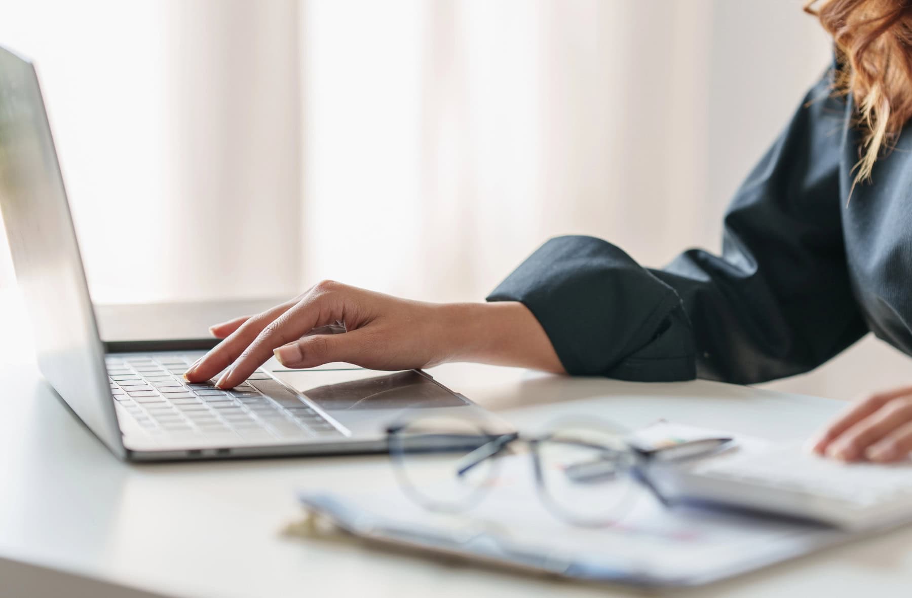 Close up Business woman hand using calculator to calculate on laptop the company's financial results and budget. Account Audit Concept